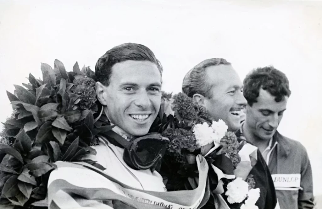 30 Jim Clark celebrates his triumph with the Lotus Type 38 Motor16